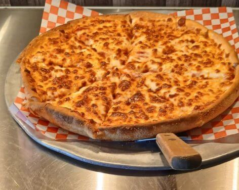 Cheese pizza on a metal serving tray. Indian Restaurant in Folsom for Unique Indian-Style Pizza.